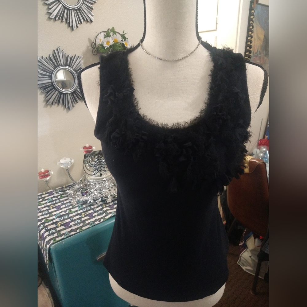 Ruffled with feathers/fabric on this black tank